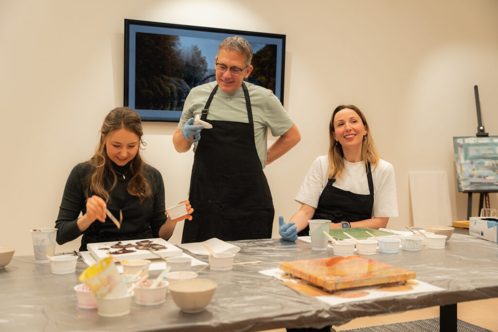 alt="Guests creating during an art class at Dharma Resort"
