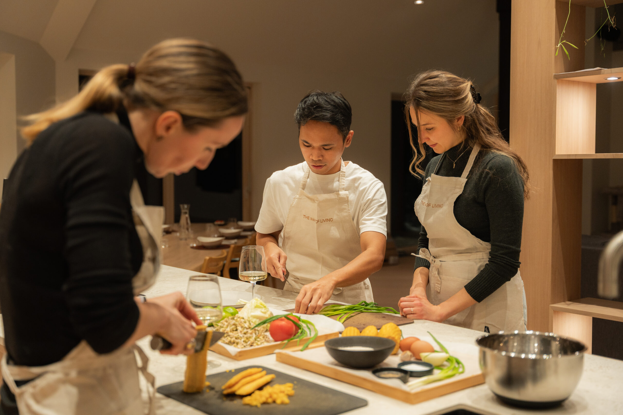 alt="Guests preparing ingredients during a cooking class at Dharma Resort"